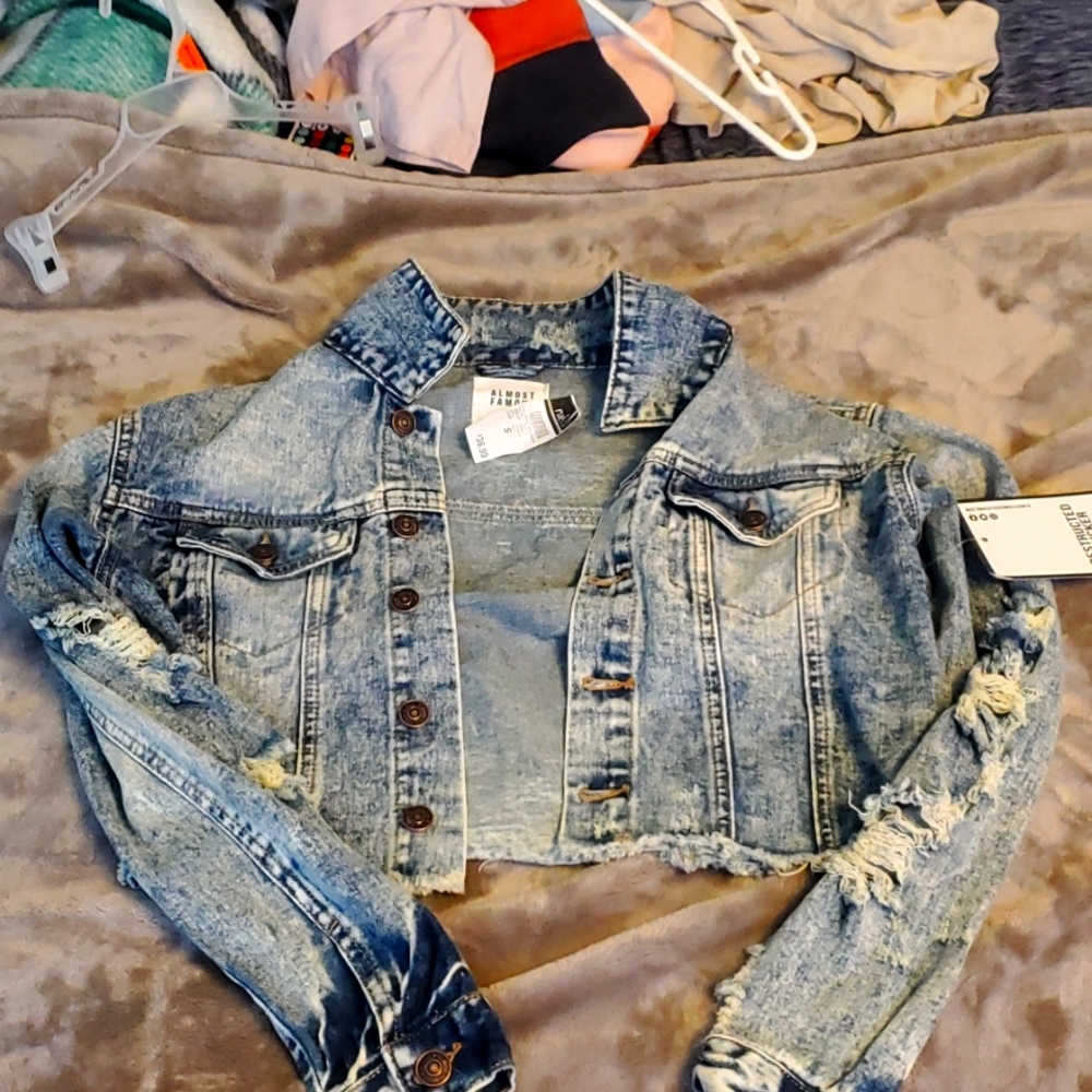 Never worn, ripped denim jacket